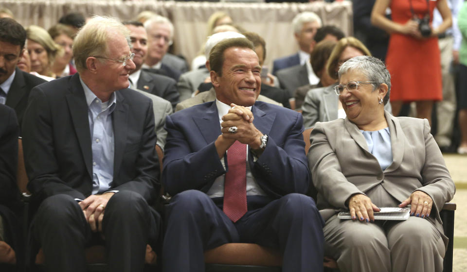 FILE - In this Sept. 8, 2014, file photo, former California Gov. Arnold Schwarzenegger, center, talks with actor Ed Begley Jr. and Mary Nichols, chair of the California Air Resources Board, in Sacramento, Calif. Nichols' term leading the board ends in December. She's held the role since 2007 after an earlier stint as chair in the early 1980's. (AP Photo/Rich Pedroncelli, File)