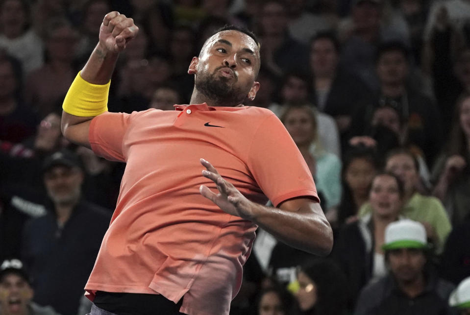 Australia's Nick Kyrgios celebrates after defeating France's Gilles Simon in their second round singles match at the Australian Open tennis championship in Melbourne, Australia, Thursday, Jan. 23, 2020. (AP Photo/Lee Jin-man)