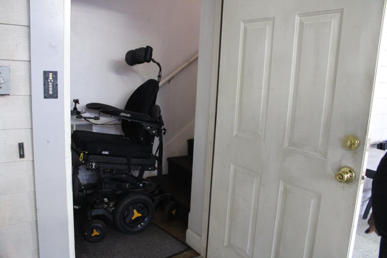 Jewel Currie's wheelchair sits wedged by the stairs in his apartment.