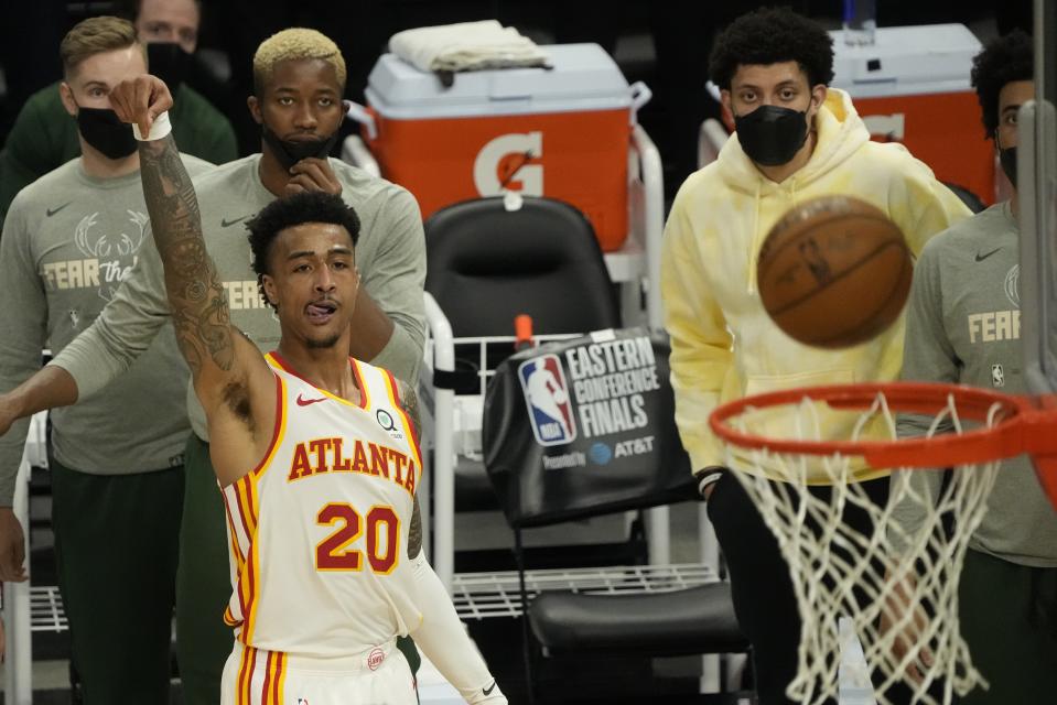 Atlanta Hawks' John Collins makes a three-point basket during the second half of Game 1 of the NBA Eastern Conference basketball finals game against the Milwaukee Bucks Wednesday, June 23, 2021, in Milwaukee. (AP Photo/Morry Gash)