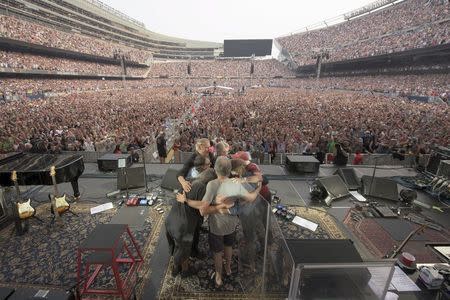 The rock band The Grateful Dead embraces during their final concert at Soldier Field stadium in Chicago, Illinois July 5, 2015, in this handout courtesy of Jay Blakesberg. REUTERS/Copyright by Jay Blakesberg/Handout