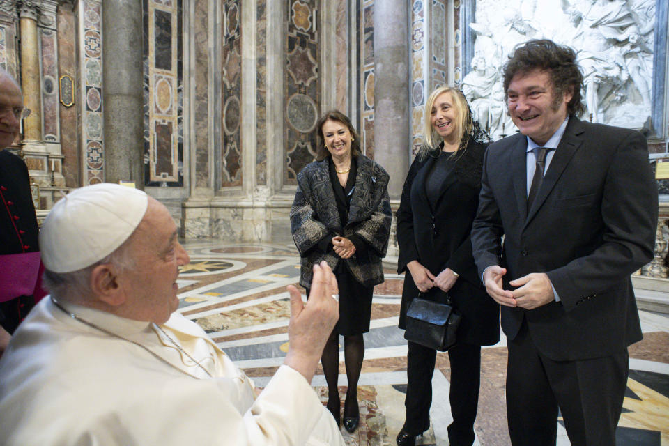In this image made available by Vatican Media, Pope Francis greets, from right, Argentine President Javier Milei, his sister and Secretary-General of the Presidency Karina Milei, and Foreign Minister Diana Mondino prior to the start of the canonization mass of Argentine first female saint, María Antonia de Paz y Figueroa also known as "Mama Antula" presided over by Pope Francis in St. Peter's Basilica at The Vatican, Sunday, Feb. 11, 2024. (Vatican Media via AP, HO)