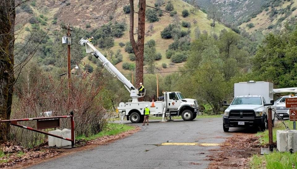 National Park Service workers working on electrical lines in the El Portal Trailer Park in El Portal, California, on March 15, 2022. Residents said power was shut off on Tuesday to the mobile homes they own there.