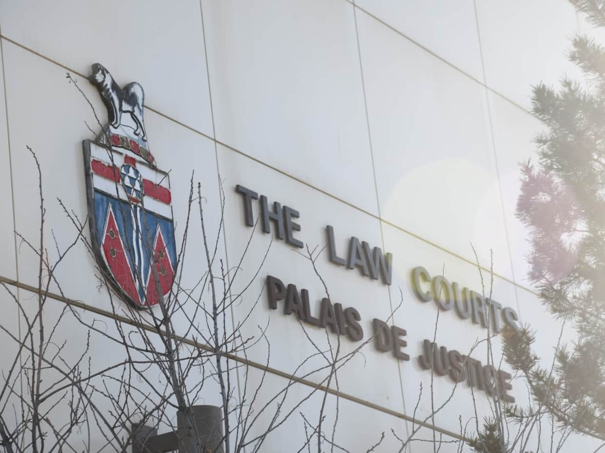 The close-up of the sign on the side of the courthouse in Whitehorse. (Jackie Hong/CBC - image credit)