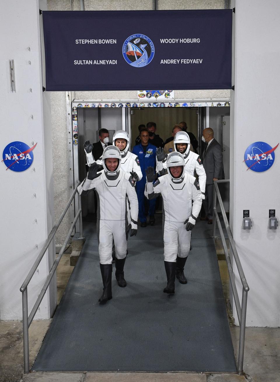 Members of the SpaceX Dragon Crew-6 mission; Pilot Warren "Woody" Hoburg (front L), Commander Stephen Bowen (front R), Mission Specialist Andrey Fedyaev of Roscosmos (back L), and Mission Specialist Sultan Alneyadi from the Mohammed bin Rashid Space Centre of the United Arab Emirates (back R) gesture during the crew walkout ahead of their expected lift off at NASA's Kennedy Space Center in Cape Canaveral, Florida, on February 26, 2023.