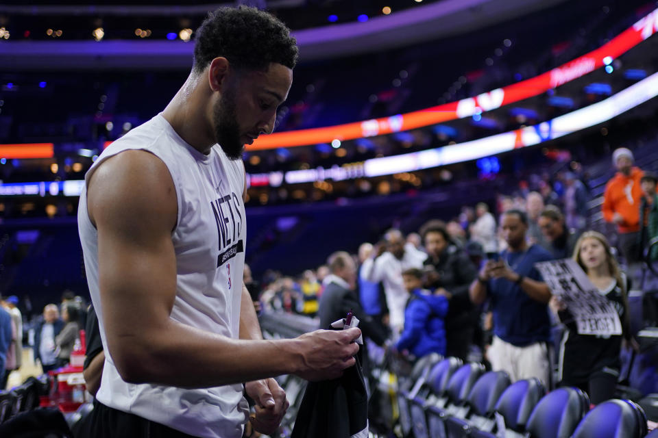 Brooklyn Nets' Ben Simmons signs autographs for fans before an NBA basketball game against the Philadelphia 76ers, Tuesday, Nov. 22, 2022, in Philadelphia. (AP Photo/Matt Slocum)