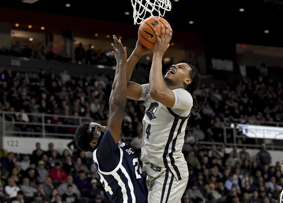 Providence's Corey Floyd, Jr. (14) fails on a layup blocked by Butler's Ali Ali (24) during the first half of an NCAA college basketball game, Wednesday, Jan. 25, 2023, in Providence, R.I. (AP Photo/Mark Stockwell)