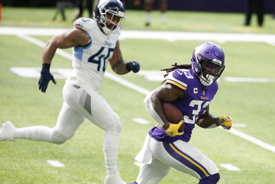 Minnesota Vikings running back Dalvin Cook runs from Tennessee Titans outside linebacker Kamalei Correa (40) during a 39-yard touchdown run in the first half of an NFL football game, Sunday, Sept. 27, 2020, in Minneapolis. (AP Photo/Bruce Kluckhohn)