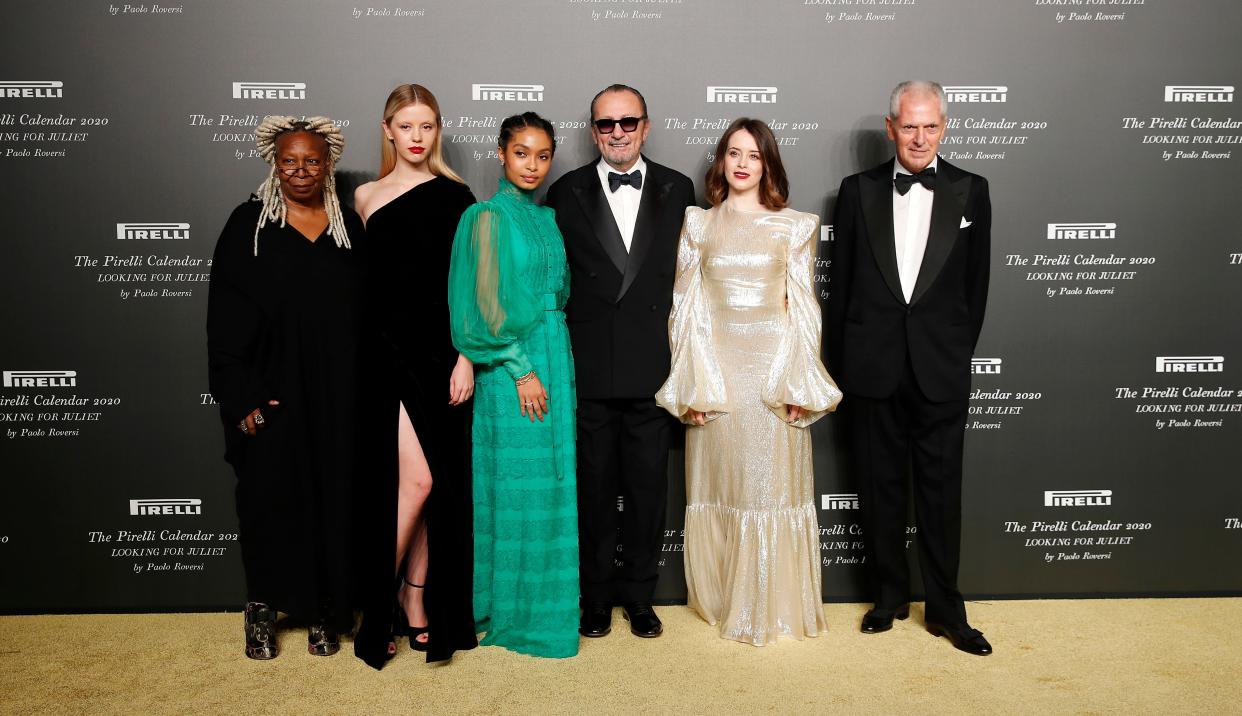 From left, Whoopi Goldberg, Mia Goth, Yara Shahidi, Italian photographer Paolo Roversi, Claire Foy and Pirelli CEO Marco Tronchetti Provera at the 2020 Pirelli Calendar event in Verona, Italy, Tuesday, Dec. 3, 2019.