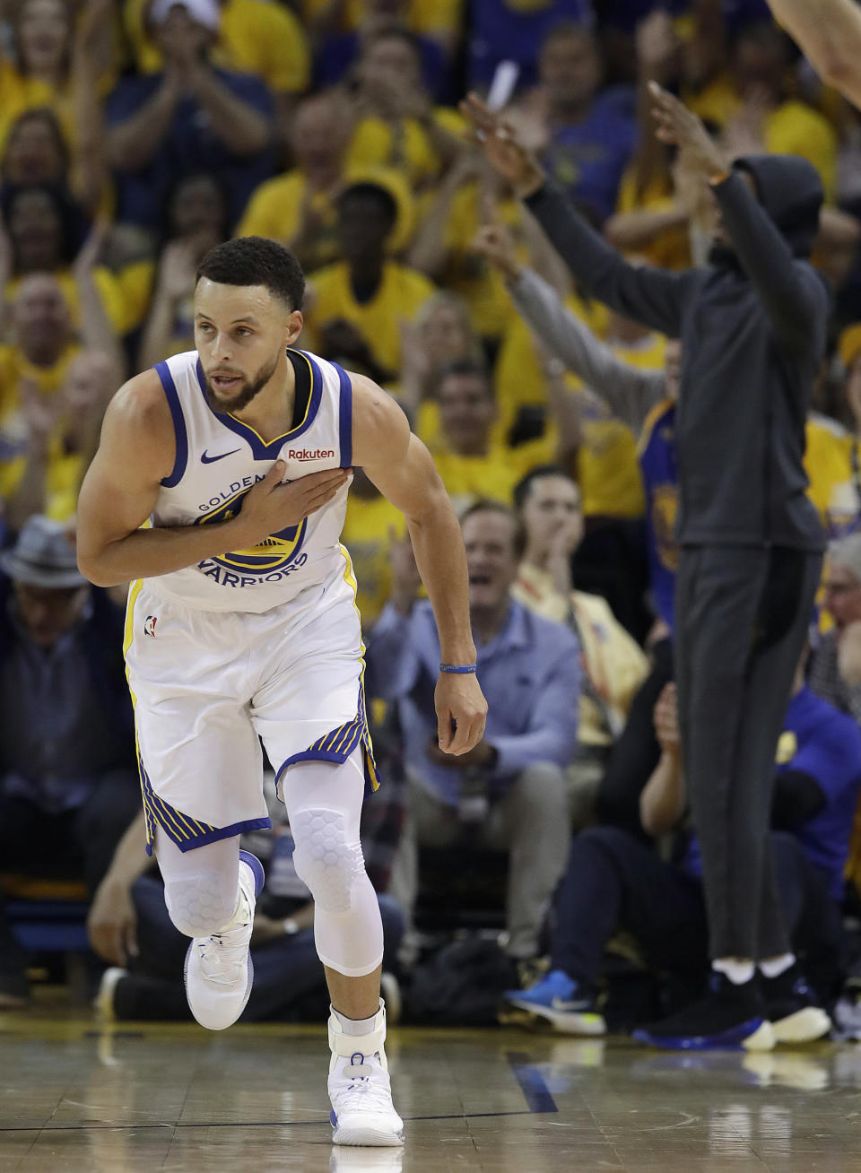 Golden State Warriors guard Stephen Curry reacts after scoring against the Houston Rockets during the first half of Game 1 of a second-round NBA basketball playoff series in Oakland, Calif., Sunday, April 28, 2019. (AP Photo/Jeff Chiu)