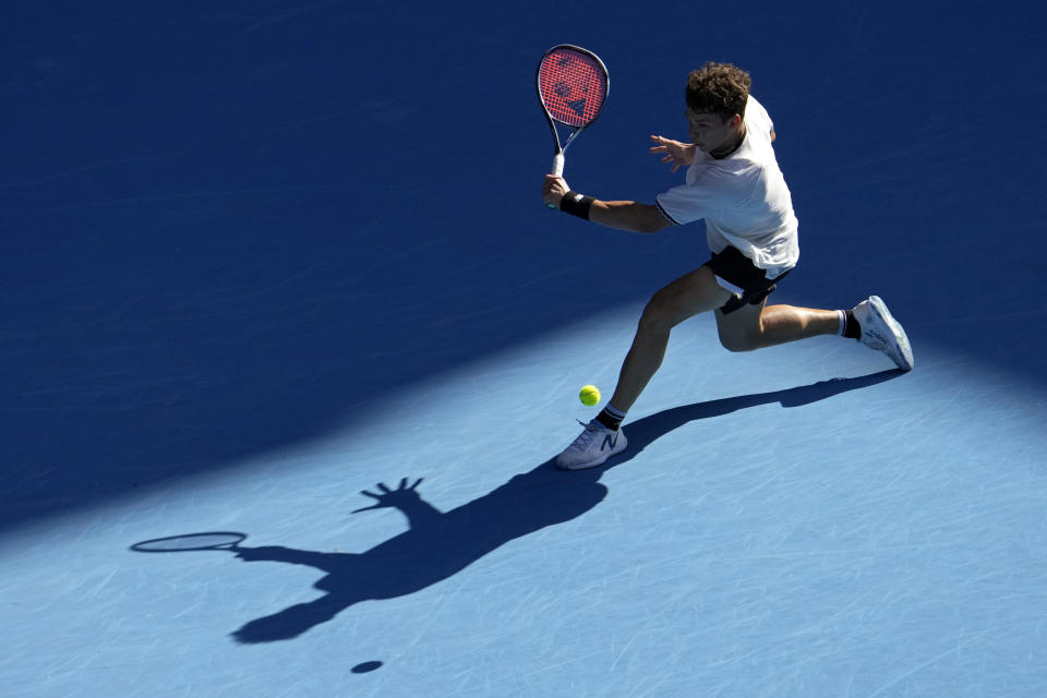 Ben Shelton of the U.S. plays a backhand return to compatriot Tommy Paul during their quarterfinal match at the Australian Open tennis championship in Melbourne, Australia, Wednesday, Jan. 25, 2023. (AP Photo/Ng Han Guan)