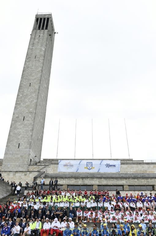 Delegations sit near the Olympic Bell Tower near the Olympic Stadium of Berlin before the official opening ceremony of the 14th European Maccabi Games in Berlin, on July 28, 2015