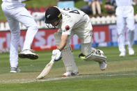 New Zealand's Tom Latham slides his bat in against India during the first cricket test between India and New Zealand at the Basin Reserve in Wellington, New Zealand, Saturday, Feb. 22, 2020. (AP Photo/Ross Setford)