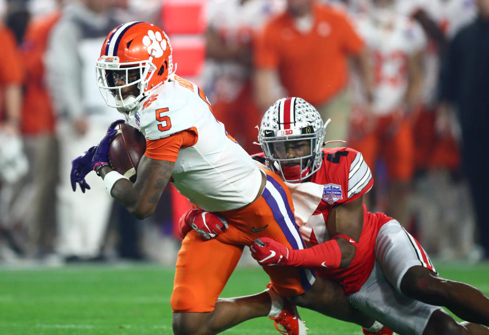 Dec 28, 2019; Glendale, AZ, USA; Clemson Tigers wide receiver Tee Higgins (5) is tackled by Ohio State Buckeyes safety <a class="link " href="https://sports.yahoo.com/nfl/players/32869/" data-i13n="sec:content-canvas;subsec:anchor_text;elm:context_link" data-ylk="slk:Jordan Fuller;sec:content-canvas;subsec:anchor_text;elm:context_link;itc:0">Jordan Fuller</a> (4) during the first quarter in the 2019 Fiesta Bowl college football playoff semifinal game at State Farm Stadium. Mandatory Credit: Matthew Emmons-USA TODAY Sports