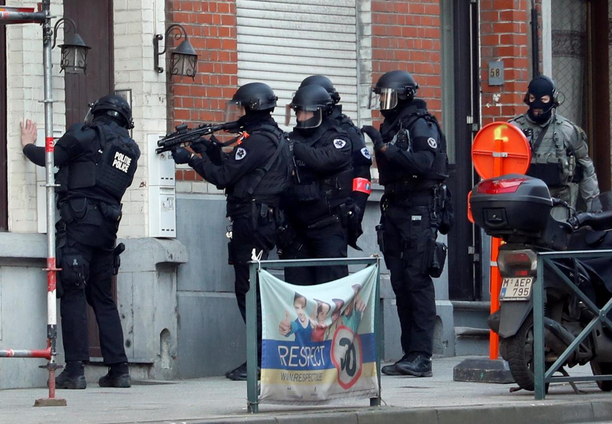 Belgian police special forces prepare to enter a building after an area of the Forest commune was put on lockdown: REUTERS