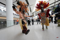 CORRECTS CITY TO KENNER, NOT BATON ROUGE- Members of the Zulu Social Aid & Pleasure Club Tramps lead a second line parade down escalators during festivities for the opening of the newly built main terminal of the Louis Armstrong New Orleans International Airport in Kenner, La., Tuesday, Nov. 5, 2019. (AP Photo/Gerald Herbert)