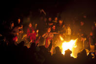 People take part in a ceremony at the Iximche archeological site to mark the end of the 13th Oxlajuj B'aktun in Tecpan, Guatemala, early Friday, Dec. 21, 2012. The end of the 13th Oxlajuj B'aktun marks a new period in the Mayan calendar, an event only comparable in recent times with the new millennium in 2000. While the Mayan calendar cycle has prompted a wave of doomsday speculation across the globe, few in the Mayan heartland believe the world will end on Friday. (AP Photo/Moises Castillo)