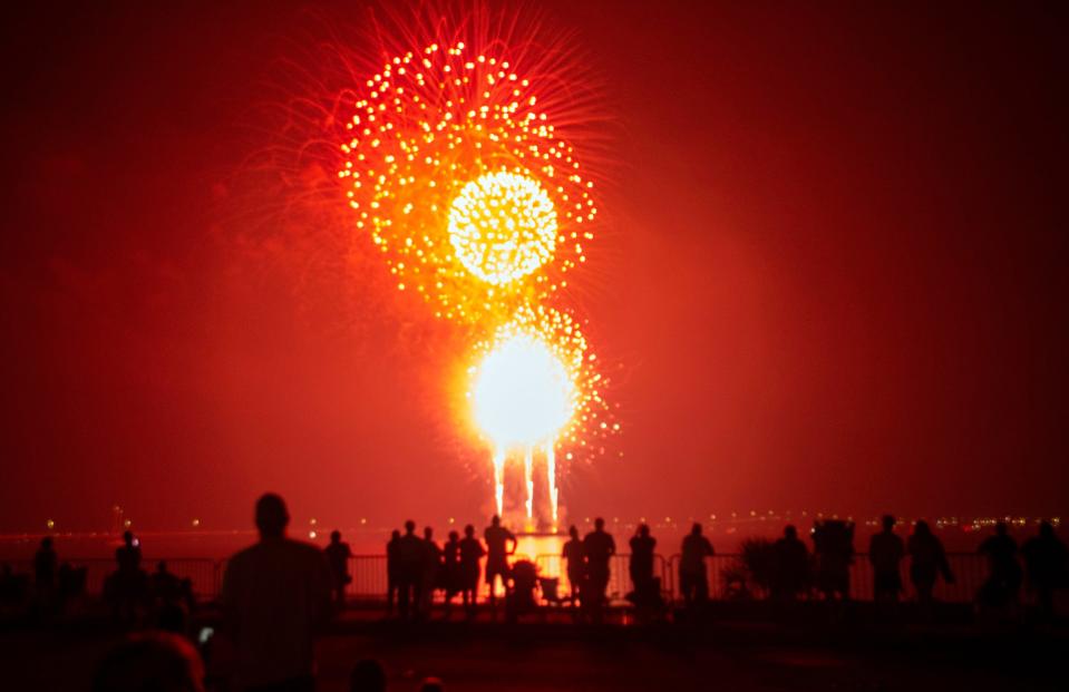 The crowd watches as fireworks light up the sky in downtown Pensacola during a previous Fourth of July fireworks show.