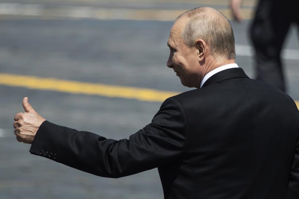 FILE - In this June 24, 2020, file photo, Russian President Vladimir Putin gestures as he leaves Red Square after the Victory Day military parade marking the 75th anniversary of the Nazi defeat in Moscow, Russia. Putin is just a step away from bringing about the constitutional changes that would allow him to extend his rule until 2036. The vote that would reset the clock on Putin’s tenure in office and allow him to serve two more six-year terms is set to wrap up Wednesday, July 1, 2020. (AP Photo/Pavel Golovkin, Pool, File)