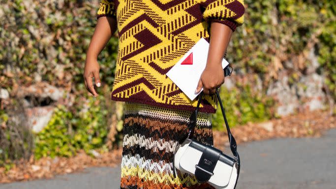 a woman wears mixed patterns at fashion week