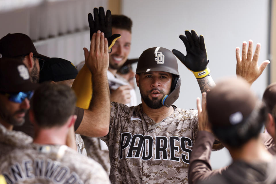 San Diego Padres' Gary Sanchez is congratulated by teammates in the dugout after hitting a solo home run against the Texas Rangers in the fifth inning of a baseball game Sunday, July 30, 2023, in San Diego. (AP Photo/Derrick Tuskan)