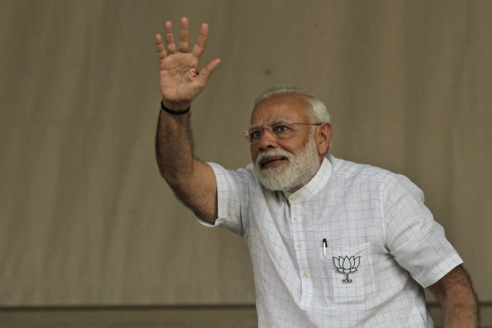 Indian Prime Minister Narendra Modi waves at an election campaign in Kolkata, India, Wednesday, April 3, 2019. India's general elections will be held in seven phases from April 11 to May 19. (AP Photo/Bikas Das)