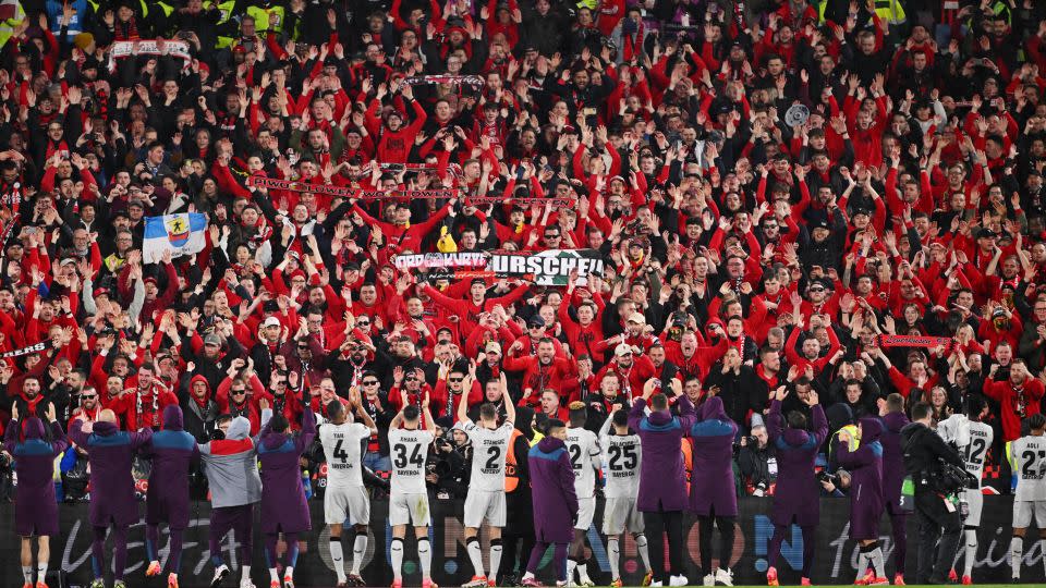 Fans of Bayer Leverkusen celebrate with the players following the side's qualification for the semifinal stage in the Europa League after quarterfinal second-leg match against West Ham United. - Mike Hewitt/Getty Images Europe/Getty Images