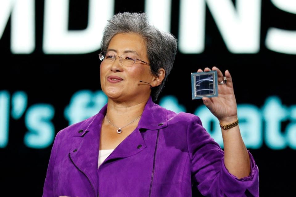 Lisa Su holding a chip.