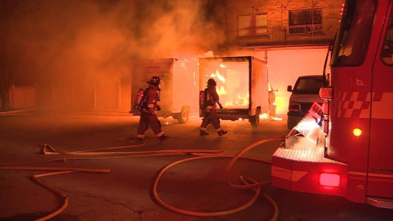 2 U-Haul trucks catch fire outside apartment building