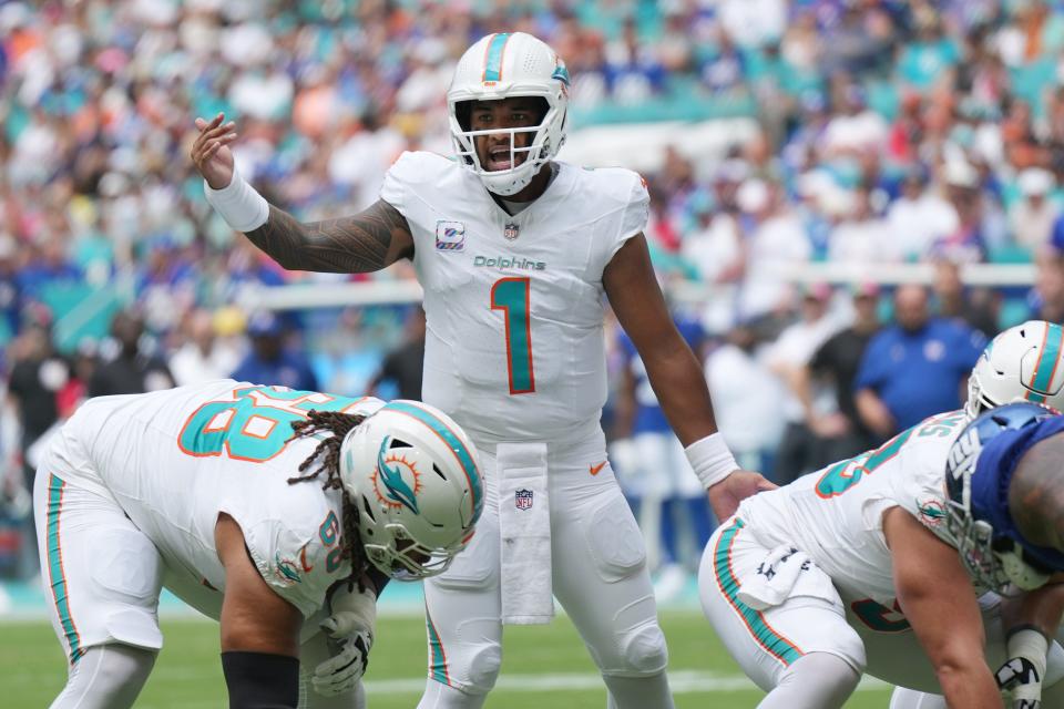 Miami Dolphins quarterback <a class="link " href="https://sports.yahoo.com/nfl/players/32675" data-i13n="sec:content-canvas;subsec:anchor_text;elm:context_link" data-ylk="slk:Tua Tagovailoa;sec:content-canvas;subsec:anchor_text;elm:context_link;itc:0">Tua Tagovailoa</a> (1) moves players around during the first half of an NFL game against the New York Giants at Hard Rock Stadium in Miami Gardens, October 8, 2023.