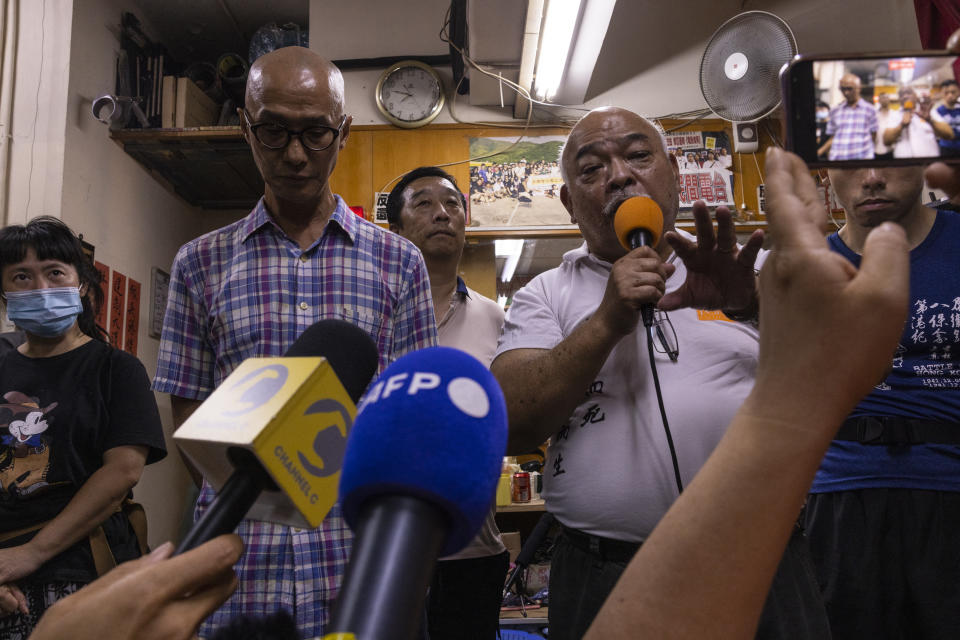 "The Bull" Tsang Kin-shing, center, founder of Hong Kong's pro-democracy Citizens' Radio station, along with radio's guests, speaks to the press prior to the radio's last broadcast in Hong Kong, Friday, June 30, 2023. (AP Photo/Louise Delmotte)