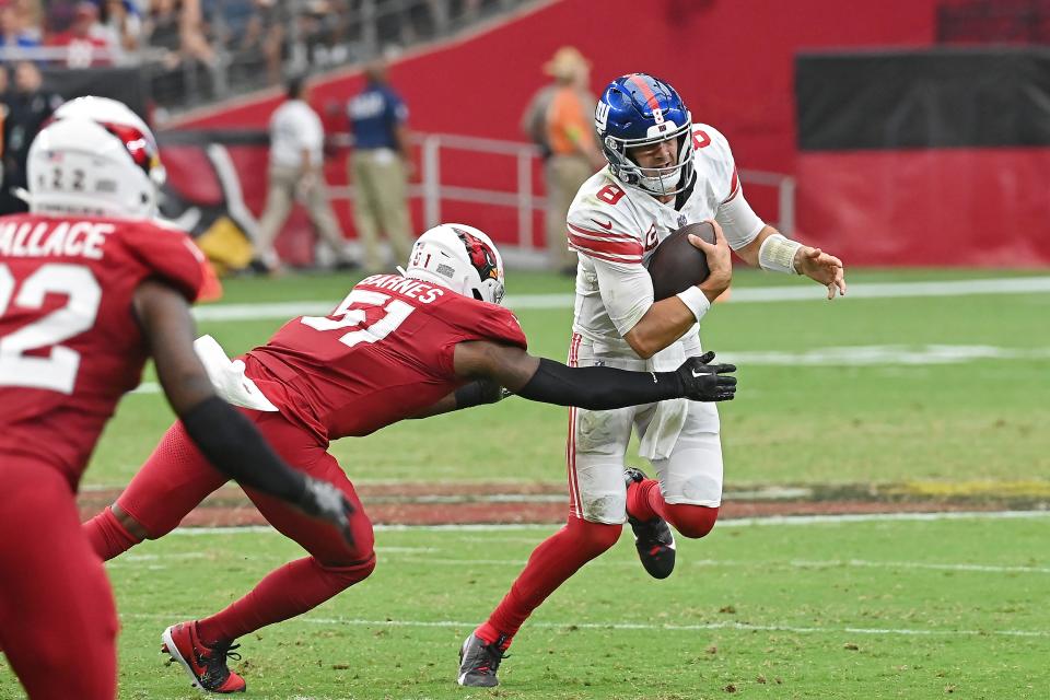 Daniel Jones #8 of the New York Giants is chased by Krys Barnes #51 of the Arizona Cardinals during the fourth quarter at State Farm Stadium in Glendale on Sept. 17, 2023.