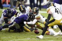 Baltimore Ravens quarterback Lamar Jackson, front left, fumbles the ball while being hit by Pittsburgh Steelers free safety Minkah Fitzpatrick (39) and inside linebacker Vince Williams (98) during the second half of an NFL football game, Sunday, Nov. 1, 2020, in Baltimore. The Steelers won 28-24. Steelers linebacker Robert Spillane (41) recovered the fumble. (AP Photo/Gail Burton)