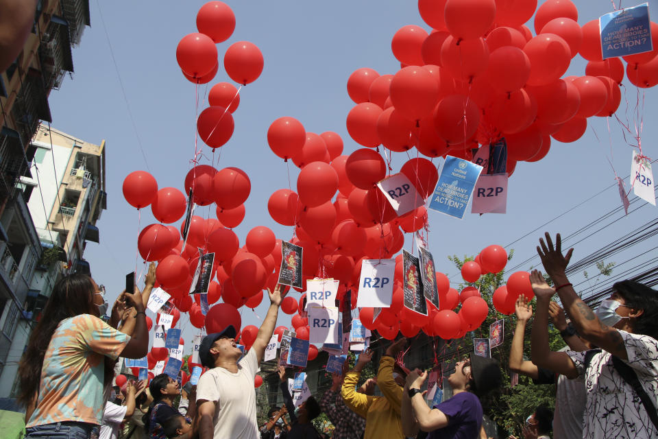 Anti-coup protesters hold red balloon, calling for foreign intervention to aid them in downtown Yangon, Myanmar, Monday, March 22, 2021. Protests against the coup continued in cities and town across the country, including Mandalay and Yangon. (AP Photo)