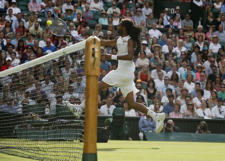 Dustin Brown of Germany hits a shot during his match against Rafael Nadal of Spain at the Wimbledon Tennis Championships in London, July 2, 2015. REUTERS/Stefan Wermuth