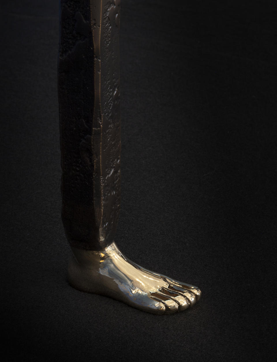 A bronze foot on a side table.