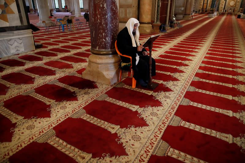 A Muslim man reads inside the al-Aqsa mosque on the compound known to Muslims as Noble Sanctuary and to Jews as Temple Mount, during their visit to Jerusalem's Old City