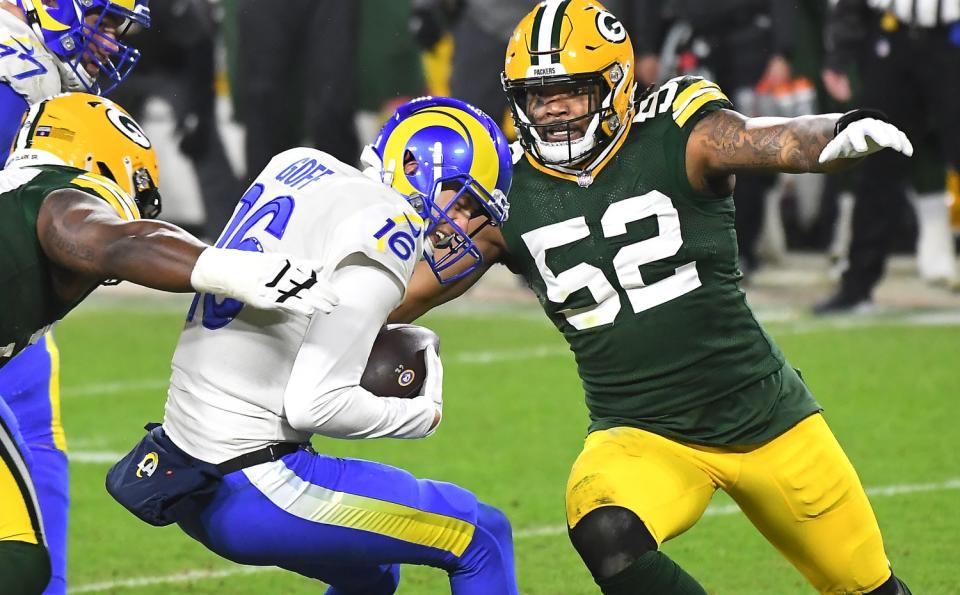 The Rams' Jared Goff is sacked as Packers defensive lineman Kenny Clark, left, closes.