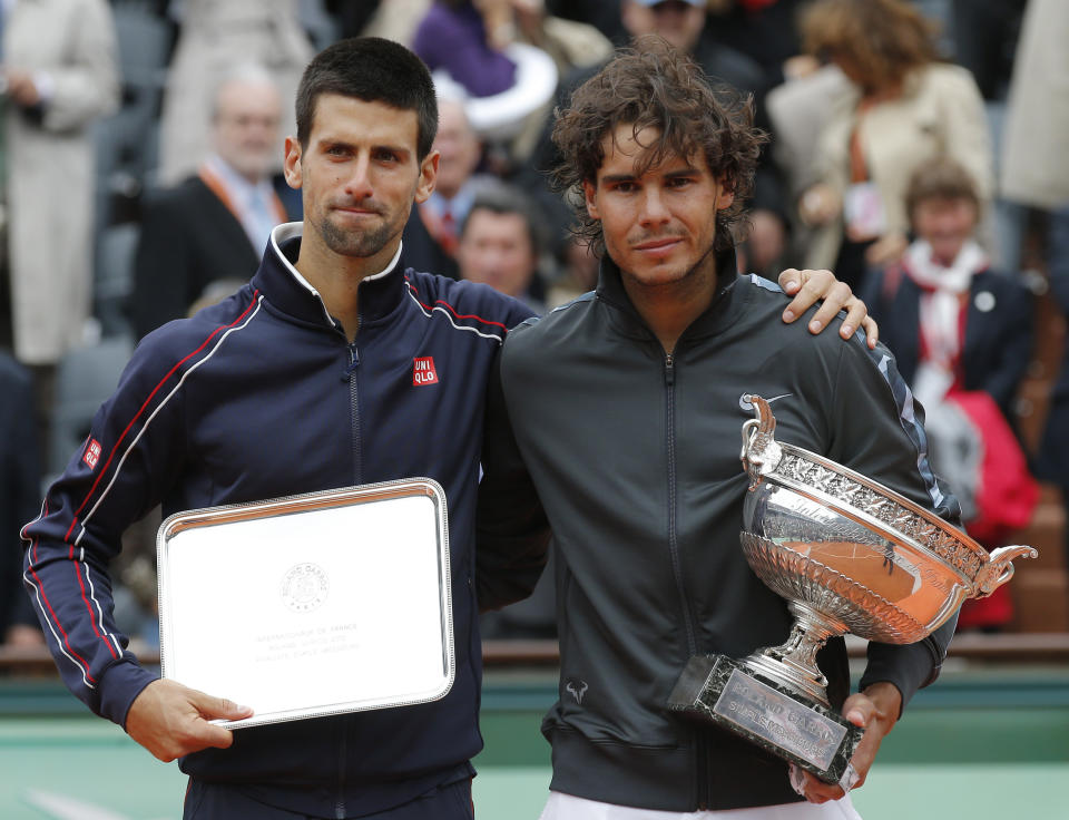 FILE - Spain's Rafael Nadal, right, and Serbia's Novak Djokovic hold their trophies after their men's final match in the French Open tennis tournament at Roland Garros stadium in Paris, Monday, June 11, 2012.(AP Photo/Michel Euler, File)