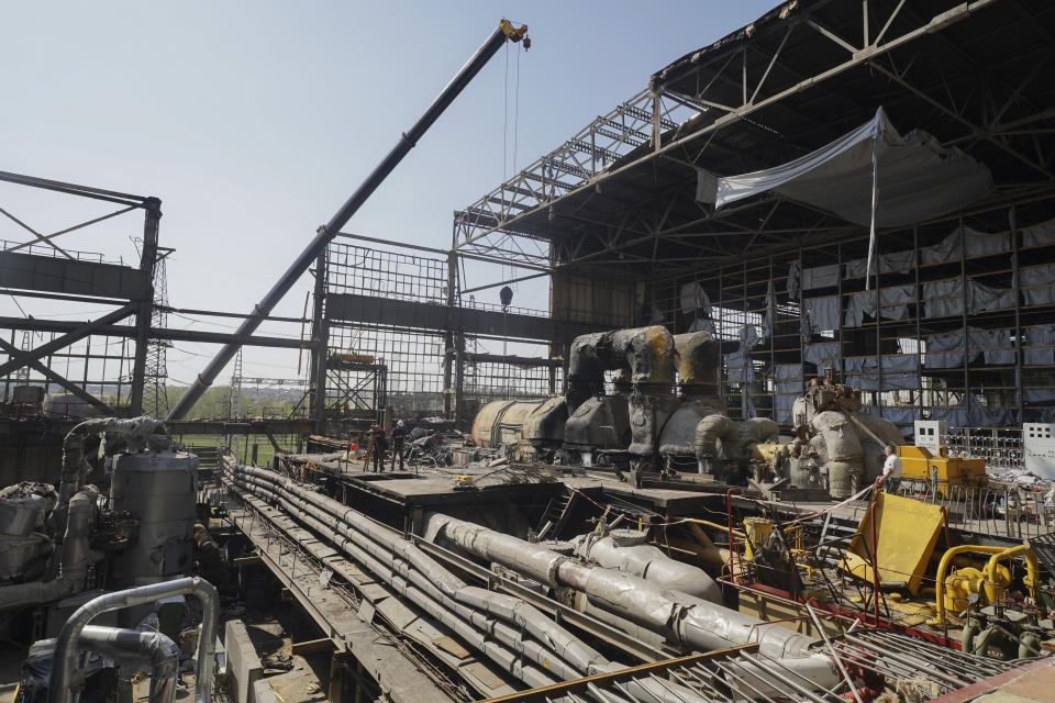 Workers repair damaged thermal power plant, one of the country's largest, recently destroyed by Russian missiles near Kharkiv, Ukraine, Friday, April 12, 2024. (AP Photo/Andrii Marienko)