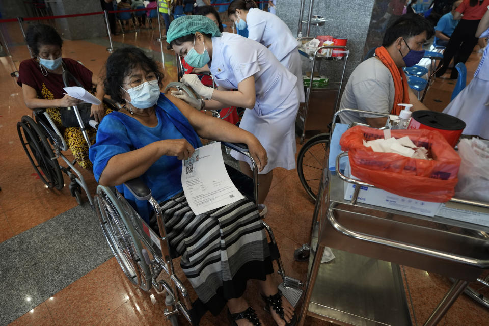 A health worker administers a dose of the Sinopharm COVID-19 vaccine to a disabled person in Bangkok, Thailand, Friday, June 25, 2021. (AP Photo/Sakchai Lalit)