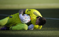 Portland Timbers goalkeeper Steve Clark makes a stop against the Colorado Rapids in the first half of an MLS Western Conference semifinal playoff soccer match, Thursday, Nov. 25, 2021, in Commerce City, Colo. (AP Photo/David Zalubowski)