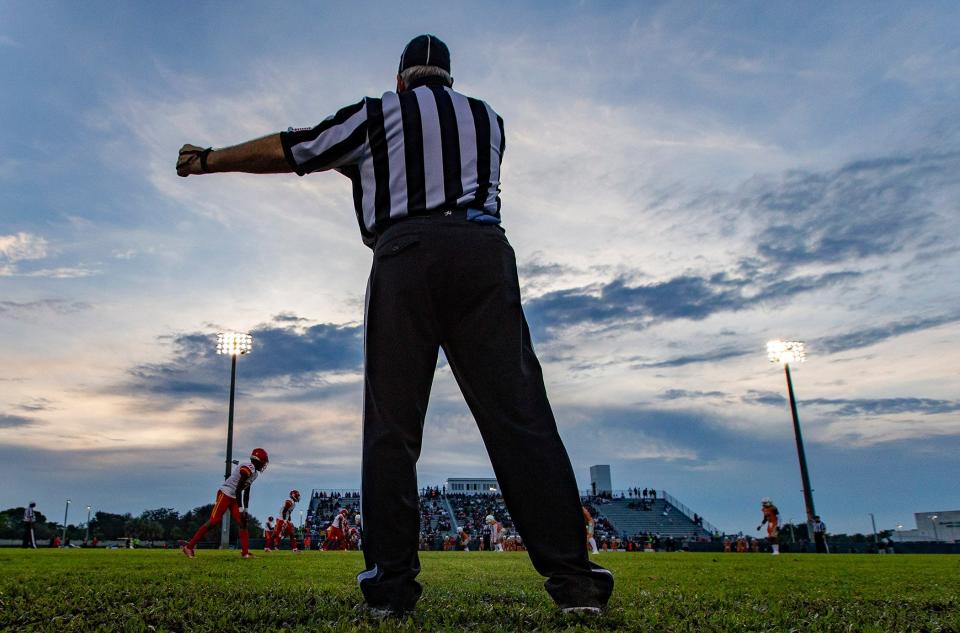 An official oversees a football game between Deerfield Beach and Atlantic High School in Delray Beach. Athletic Director Andrea Smith-Thomas was in charge of tracking and collecting ticket and parking sales money for the home football games during her three-year tenure as the school's athletic director.