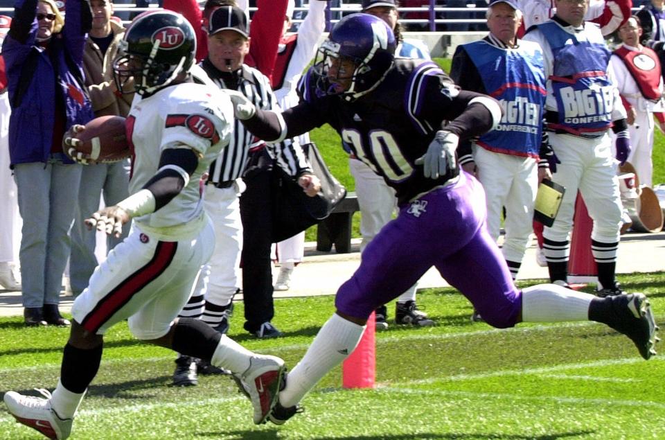 Northwestern's Rashidi Wheeler, right, chases an  Indiana player into the end zone in Evanston, Ill., in this Oct. 7, 2000 photo.