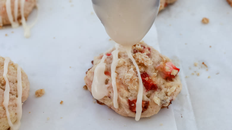 glaze being drizzled onto cookies