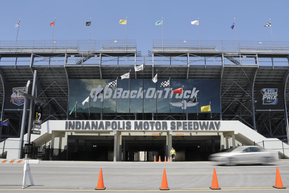 A car drives past an entrance to the Indianapolis Motor Speedway in Indianapolis, Thursday, July 2, 2020. Roger Penske has spent the six months since he bought Indianapolis Motor Speedway transforming the facility. He's spent millions on capital improvements to the 111-year-old national landmark and finally gets to showcase some of the upgrades this weekend as NASCAR and IndyCar share the venue in a historic doubleheader. (AP Photo/Darron Cummings)