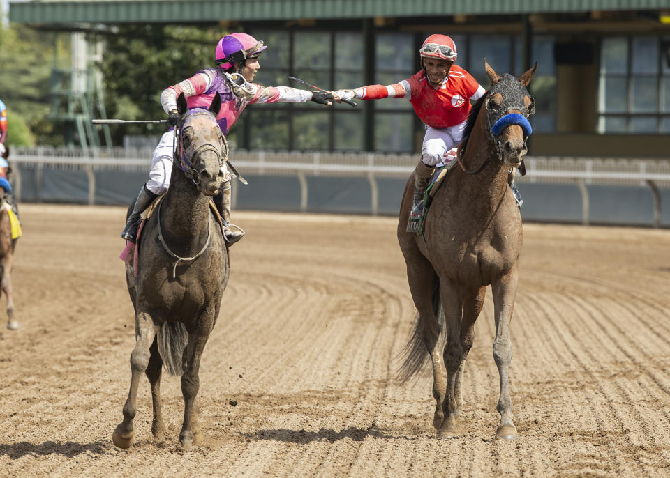 In this image provided by Benoit Photo, jockey Kazushi Kimura, left, aboard Mandarin Hero, who finished second, congratulates jockey Ramon Vazquez, aboard Practical Move after winning the Santa Anita Derby horse race, Saturday, April 8, 2023 at Santa Anita Park in Arcadia, Calif. (Benoit Photo via AP)