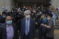 Pro-democracy activists Martin Lee, center, and Albert Ho, left, arrive at a court in Hong Kong Friday, April 16, 2021. Seven of Hong Kong’s leading pro-democracy advocates, including Lee and pro-democracy media tycoon Jimmy Lai, are expected to be sentenced Friday for organizing a march during the 2019 anti-government protests that triggered an overwhelming crackdown from Beijing. (AP Photo/Kin Cheung)