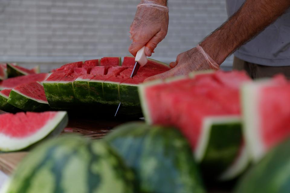 Walter Edwards, a volunteer with First Baptist Church of Lloyd, cuts watermelon during Monticello's 69th Annual Watermelon Festival Saturday, June 15, 2019. 