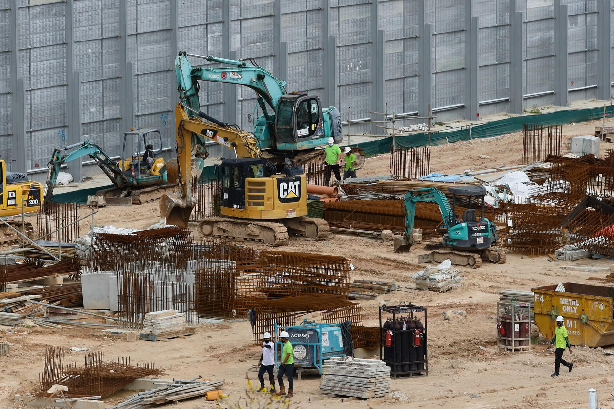 SINGAPORE - APRIL 20:  Men are seen checking on an ongoing construction site on April 20, 2020 in Singapore. Singapore government will put all construction workers holding the work permit and S pass holders on mandatory 14 days stay home notice from April 20 to combat the spread of coronavirus (COVID-19) infections.  (Photo by Suhaimi Abdullah/Getty Images)